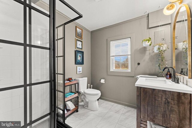 bathroom featuring baseboards, toilet, marble finish floor, crown molding, and vanity