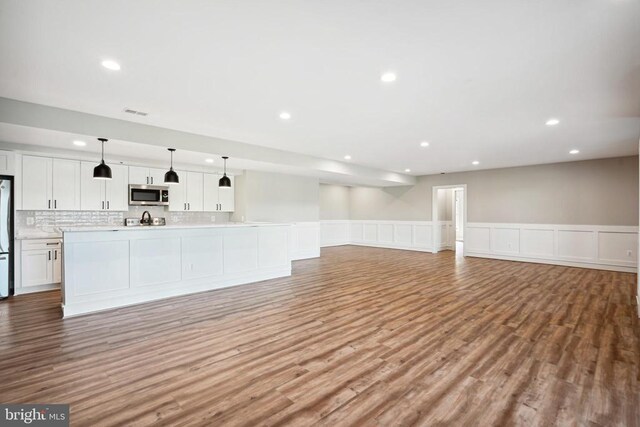 unfurnished living room with light hardwood / wood-style floors