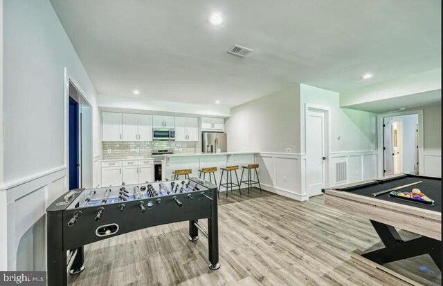 game room with pool table and light hardwood / wood-style flooring