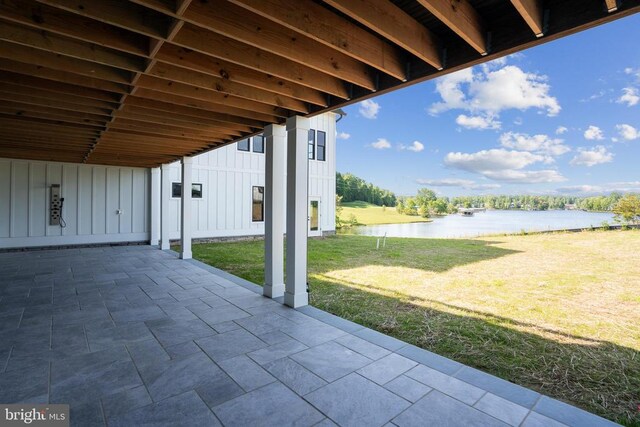 view of patio with a water view