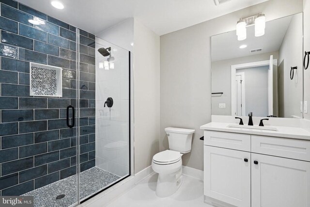 bathroom with vanity, walk in shower, tile patterned floors, and toilet