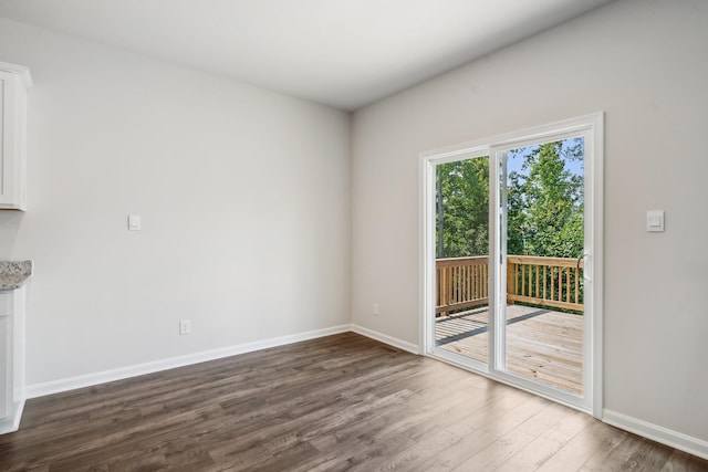 interior space featuring baseboards and dark wood-type flooring