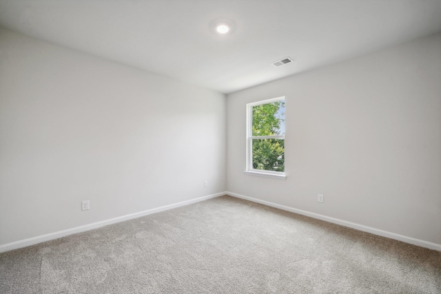 unfurnished room featuring visible vents, baseboards, and carpet flooring