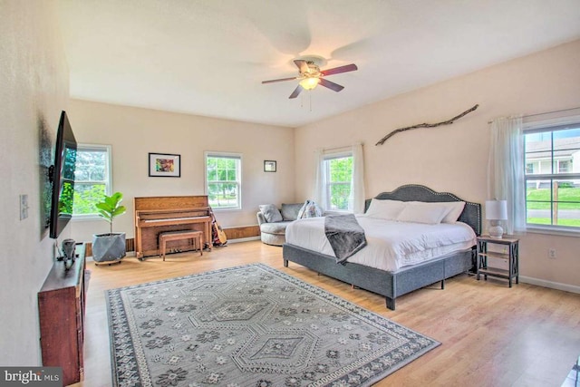 bedroom featuring wood finished floors, baseboards, and ceiling fan