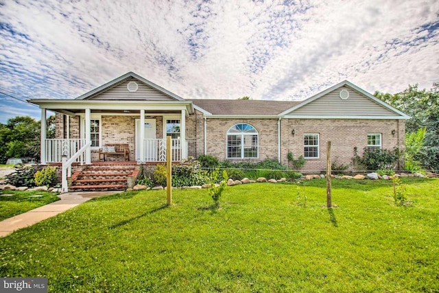 ranch-style house with a front yard, covered porch, and brick siding