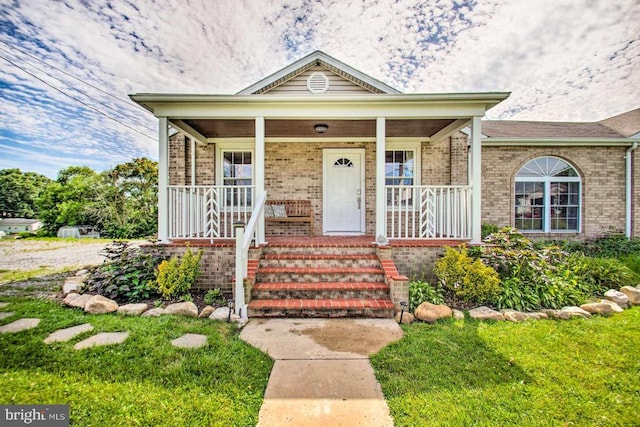 bungalow-style home with brick siding and a porch