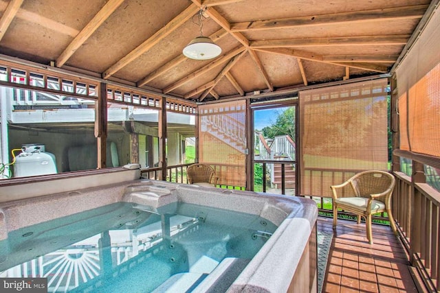 view of pool with an indoor hot tub