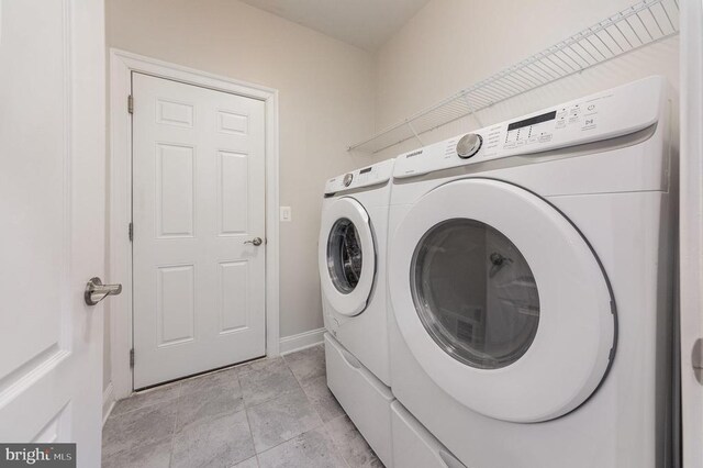 clothes washing area featuring separate washer and dryer