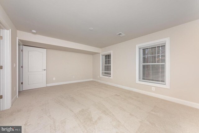 spare room with light colored carpet