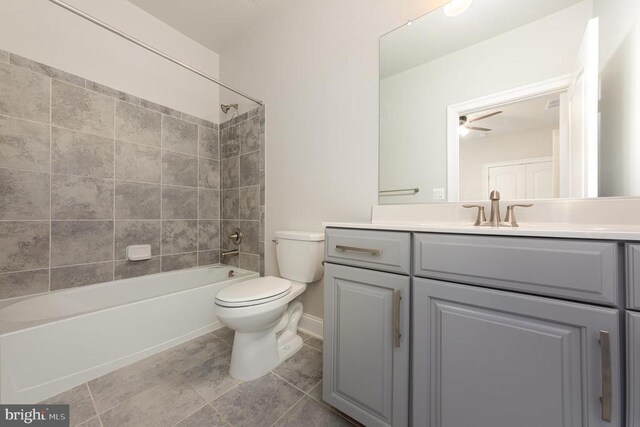 full bathroom with vanity, toilet, tiled shower / bath combo, and tile patterned flooring