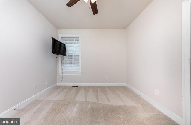 unfurnished room featuring light colored carpet and ceiling fan