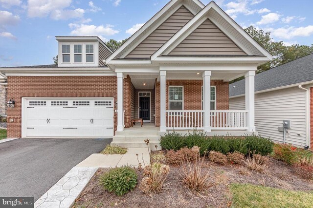 view of front facade with a garage and covered porch