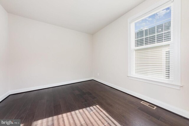 empty room with hardwood / wood-style floors