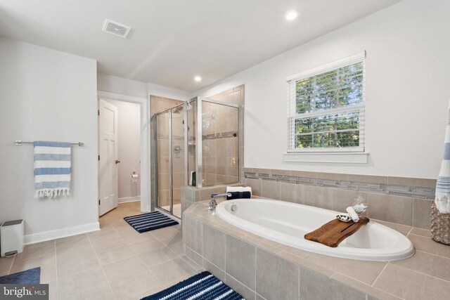 bathroom with tile patterned flooring, visible vents, baseboards, a stall shower, and a bath