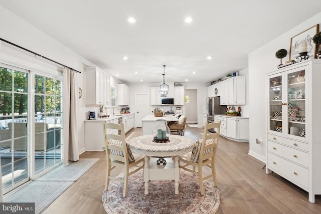 dining area featuring light wood-style flooring, recessed lighting, and baseboards