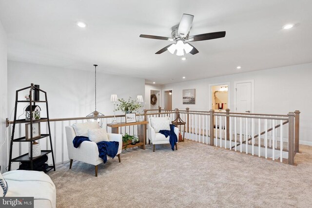 living area featuring recessed lighting, an upstairs landing, and carpet flooring