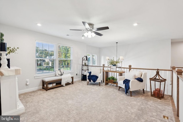 sitting room featuring recessed lighting, an upstairs landing, baseboards, and carpet floors