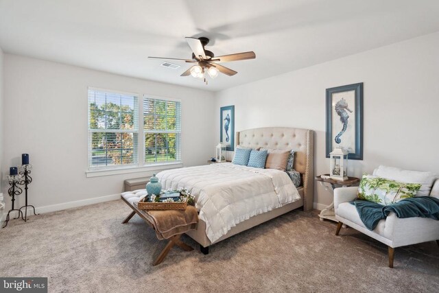 carpeted bedroom with baseboards, visible vents, and ceiling fan