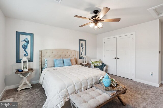 bedroom featuring a closet, carpet flooring, baseboards, attic access, and ceiling fan