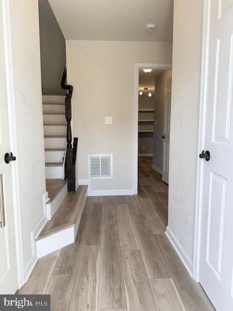 interior space with visible vents, baseboards, and wood finished floors