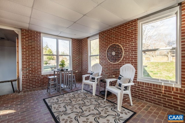 sunroom / solarium with a paneled ceiling