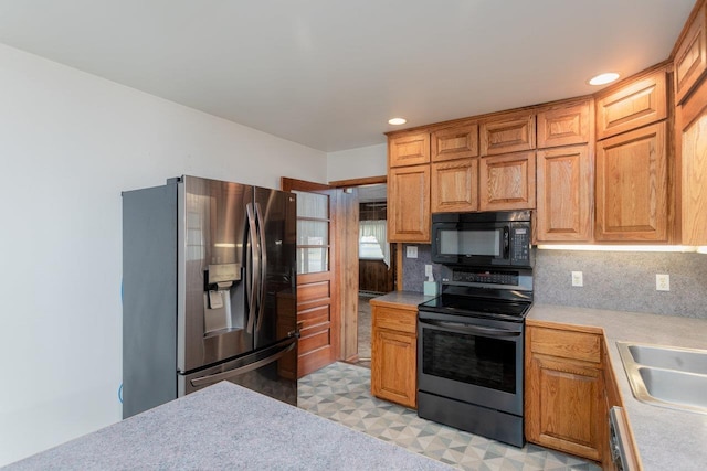 kitchen with backsplash, stainless steel appliances, and sink