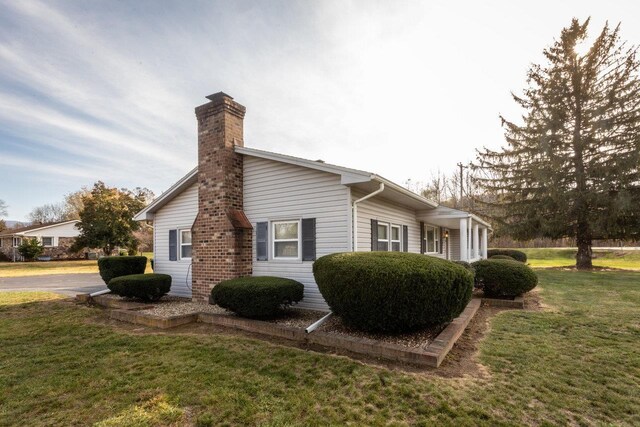 view of side of home with a lawn