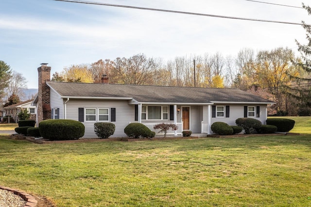 ranch-style home featuring a front lawn and a porch