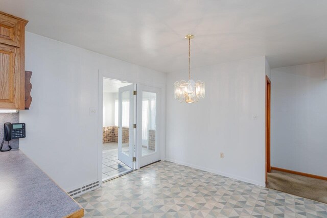 unfurnished dining area with a notable chandelier