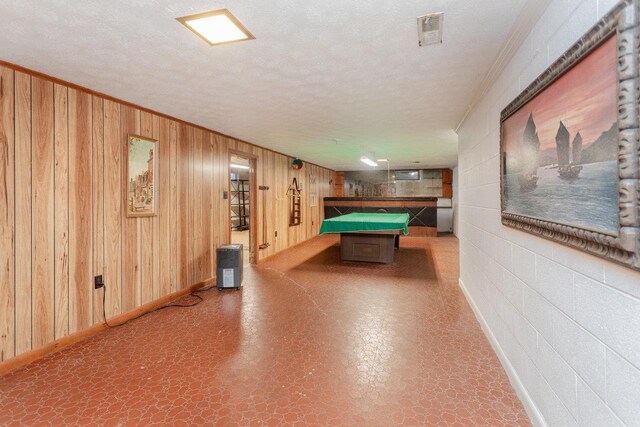 playroom with crown molding, billiards, a textured ceiling, and wood walls