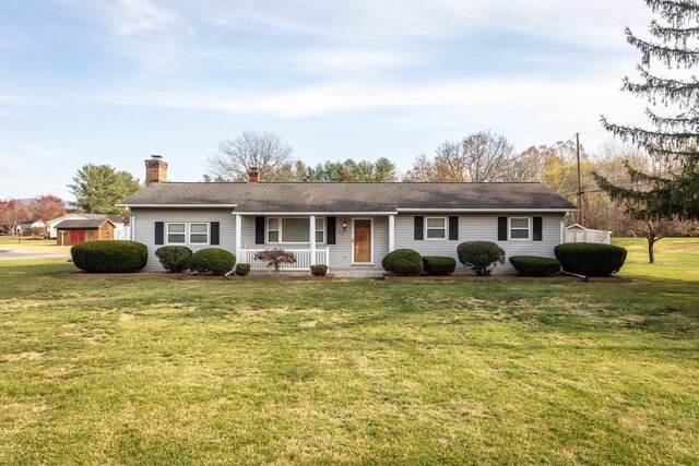 ranch-style home with a porch and a front yard