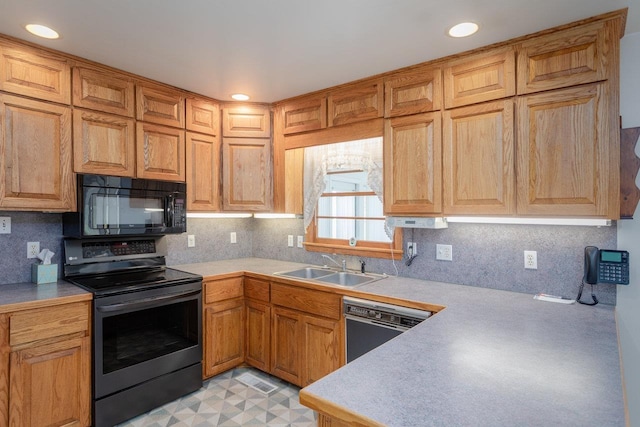 kitchen featuring tasteful backsplash, sink, and black appliances