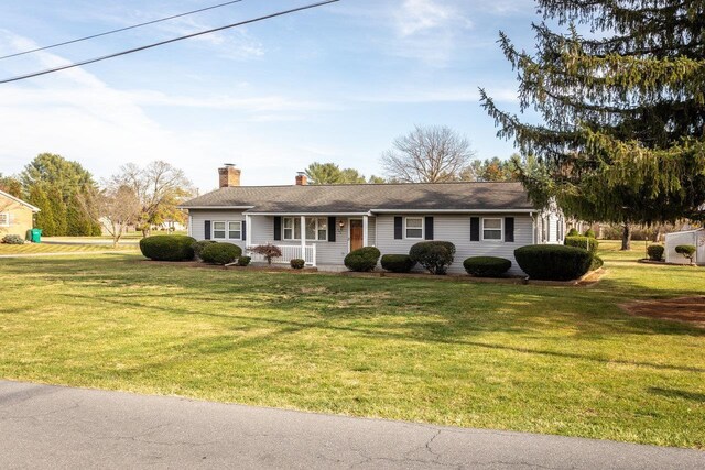 single story home with covered porch and a front lawn