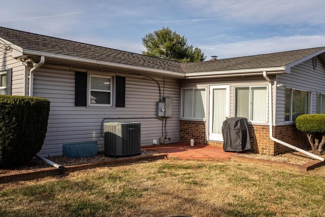 back of house with a patio, a yard, and cooling unit