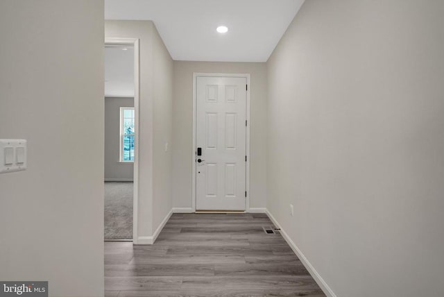 foyer entrance featuring light wood-type flooring, visible vents, and baseboards