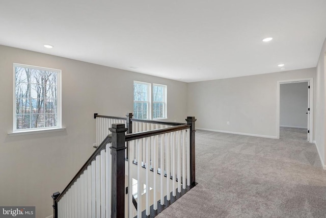 hallway with light carpet, recessed lighting, an upstairs landing, and baseboards