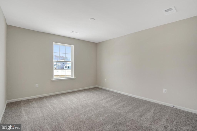 carpeted empty room with baseboards and visible vents