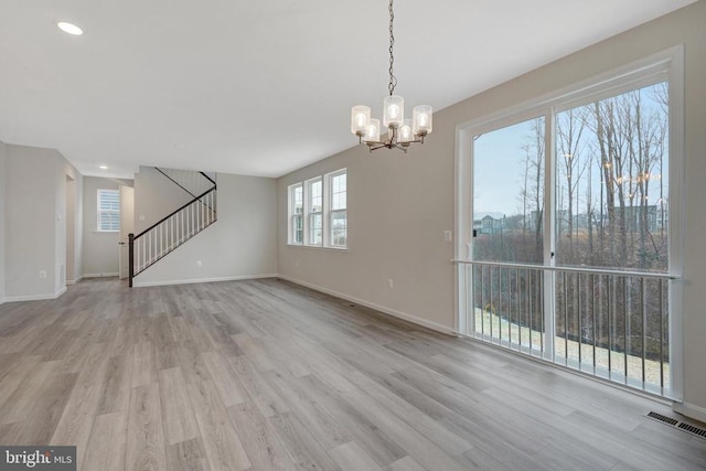 interior space with stairs, light wood-style flooring, visible vents, and baseboards