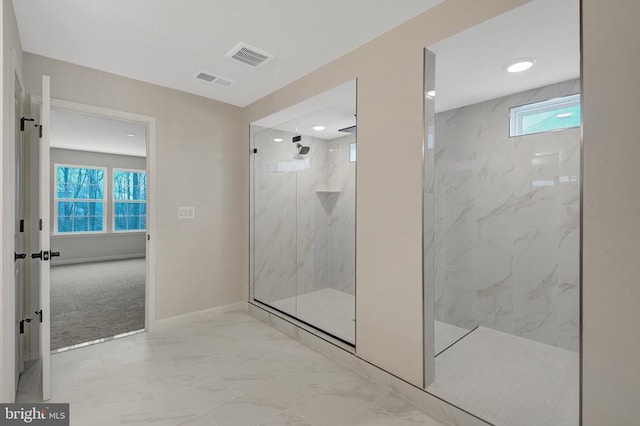 full bathroom with marble finish floor, plenty of natural light, a marble finish shower, and visible vents