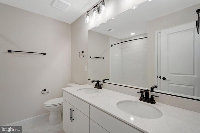 bathroom featuring visible vents, a sink, baseboards, and double vanity