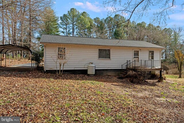 back of property with a carport