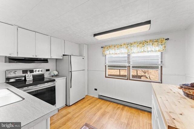 kitchen with refrigerator, white cabinetry, a baseboard radiator, sink, and stainless steel electric range