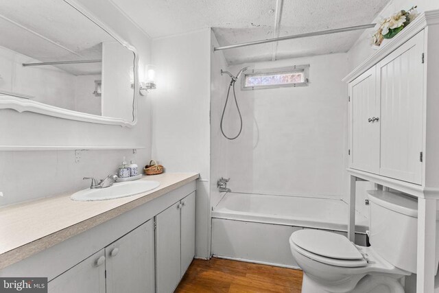 full bathroom featuring shower / washtub combination, toilet, hardwood / wood-style floors, and vanity