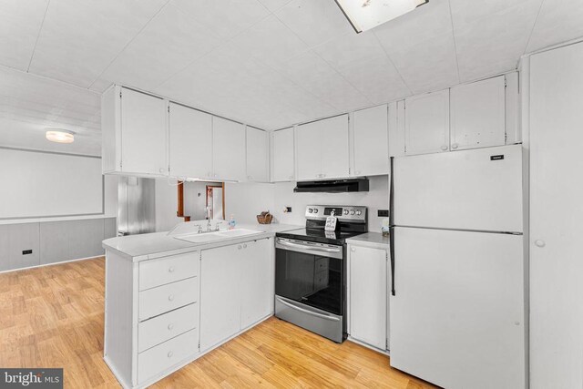 kitchen featuring sink, stainless steel range with electric cooktop, light wood-type flooring, white fridge, and white cabinets