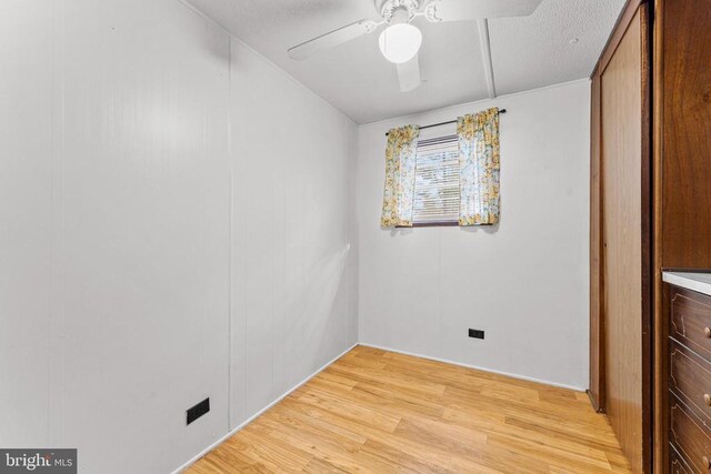 unfurnished bedroom featuring ceiling fan and light wood-type flooring