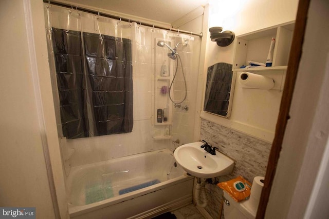 bathroom with shower / bathtub combination with curtain and sink