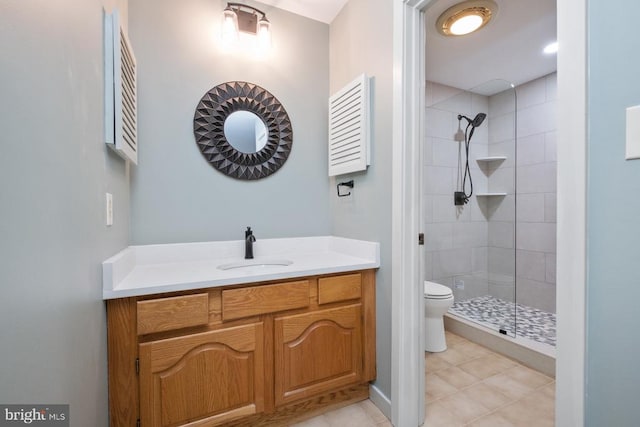 bathroom with vanity, tile patterned flooring, a shower stall, and toilet