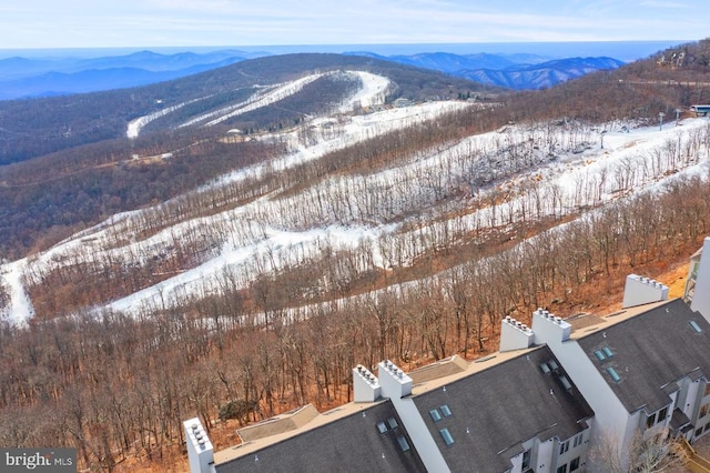 snowy aerial view featuring a mountain view