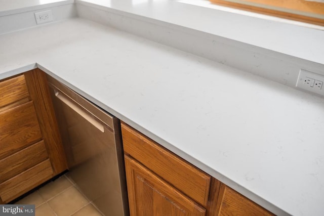 details featuring brown cabinetry, light countertops, and stainless steel dishwasher