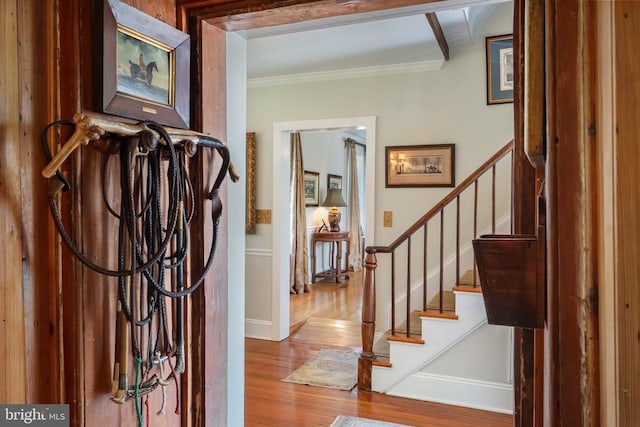 foyer entrance featuring stairway, crown molding, and wood-type flooring